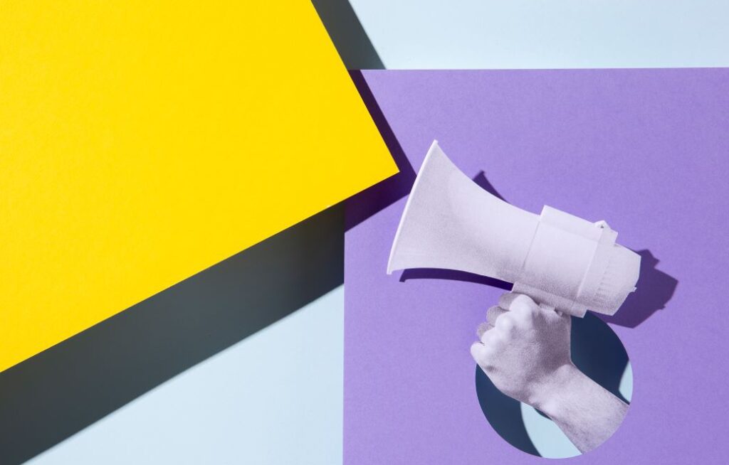hand holding megaphone paper style